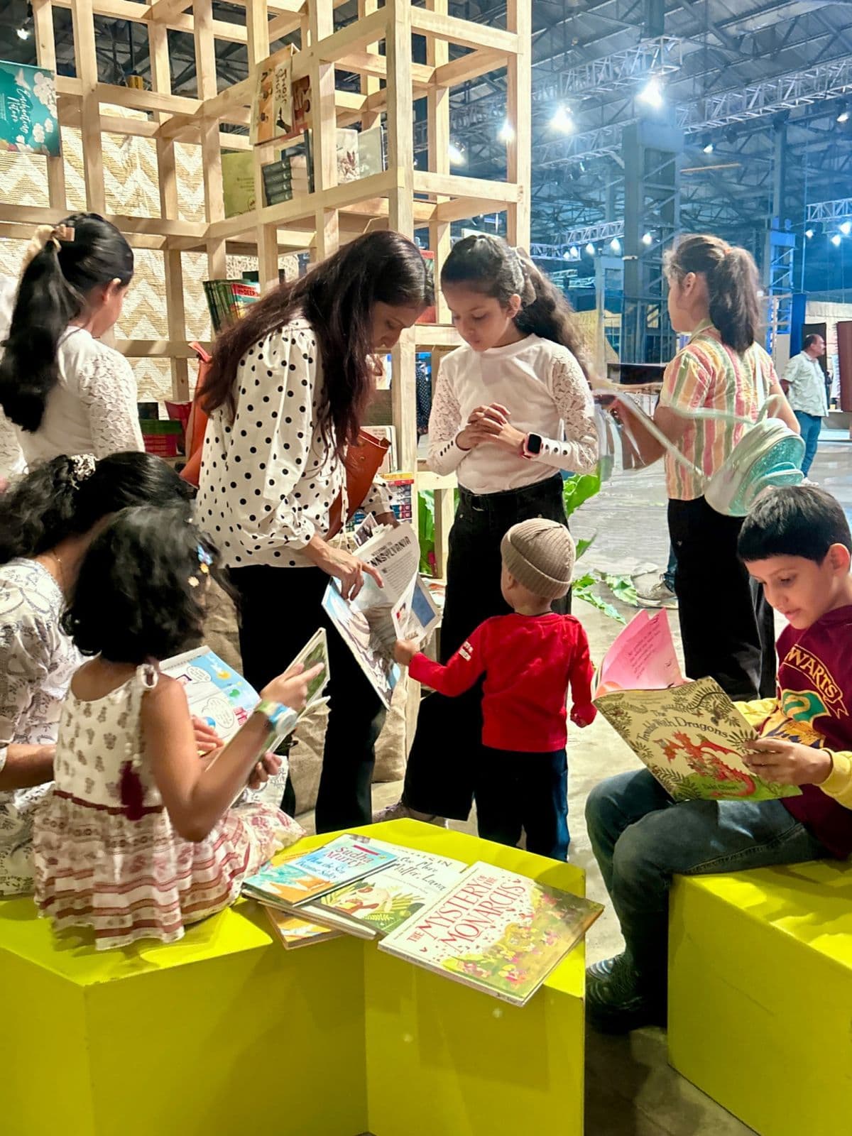 Children browsing books together at a festival pop-up