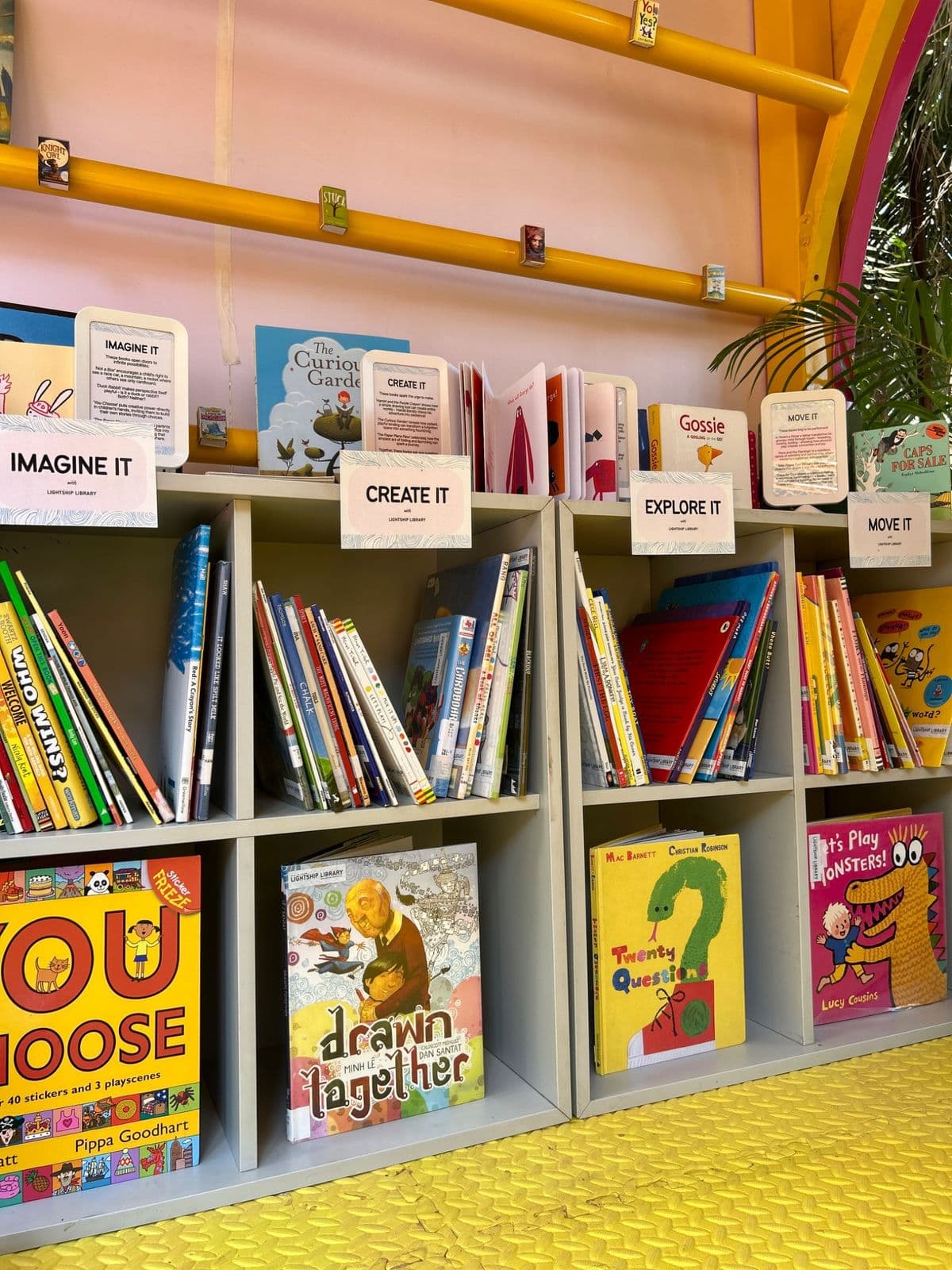 Cubby shelves in the reading room labelled Imagine It, Create It, Explore It and Move It